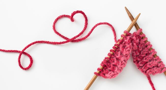 Knitting needles with red yarn