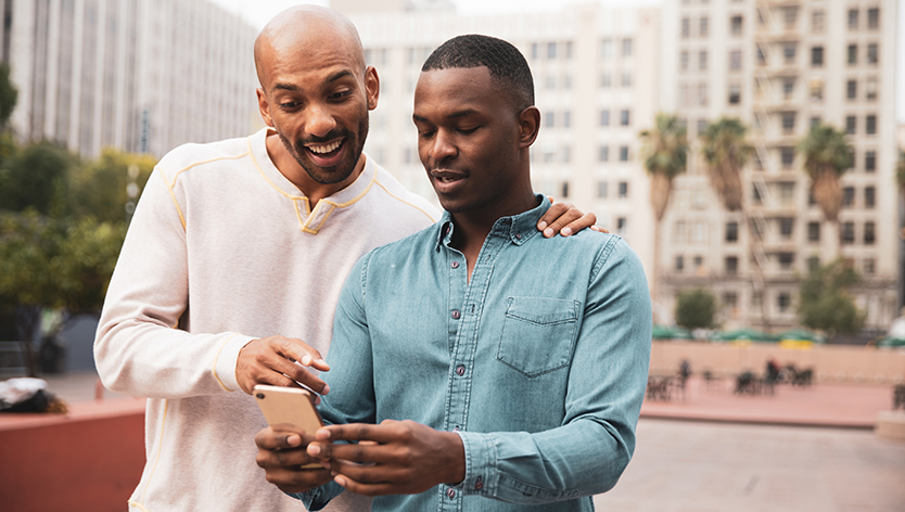 two men looking at mobile