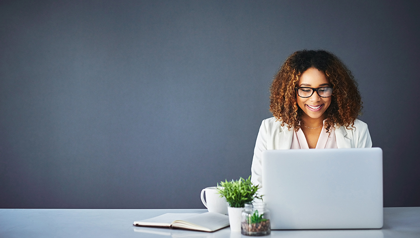 happy woman working on laptop