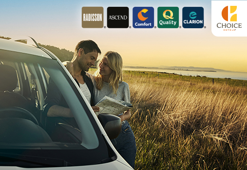 couple stand outside car looking at map, Choice logo