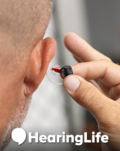 person putting hearing aid into ear, HearingLife logo