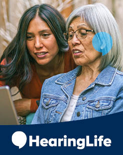 two women looking at computer, HearingLife logo