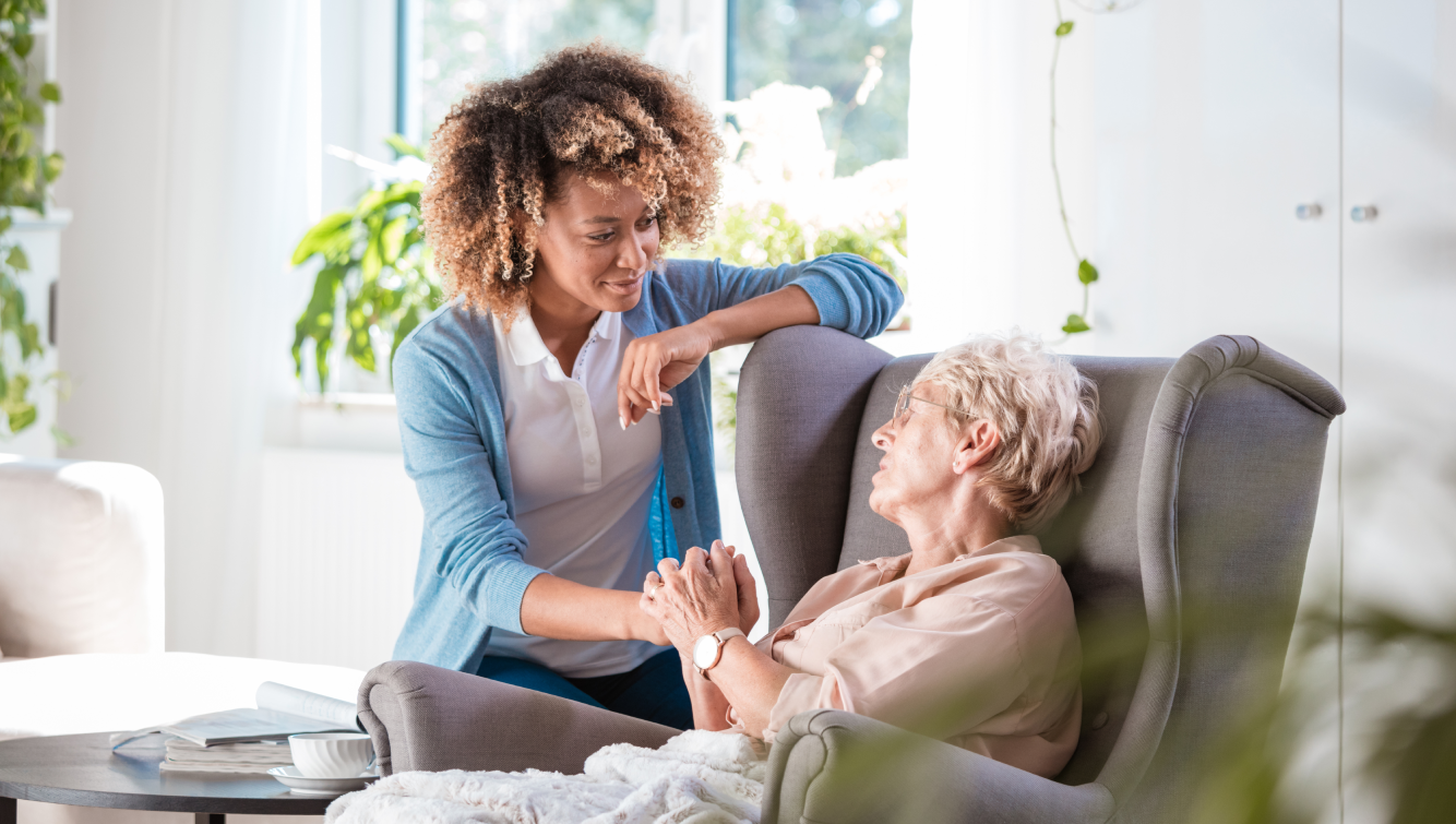 younger woman holding hands with older woman