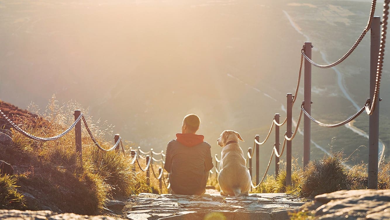 man sitting with dog