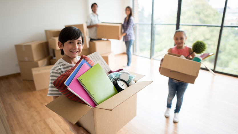 Kids holding moving boxes