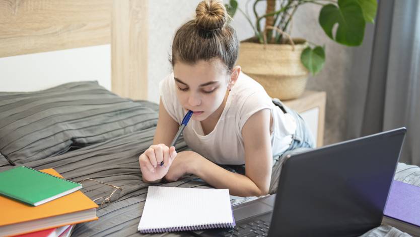 girl studying on bed