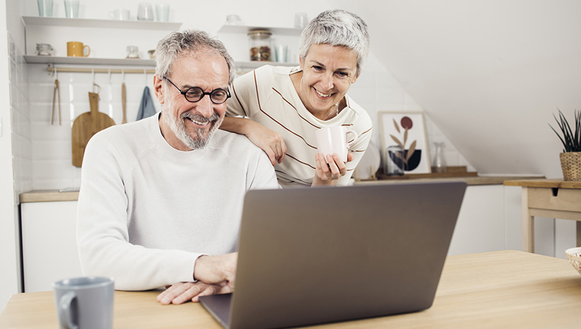 senior couple looking at laptop