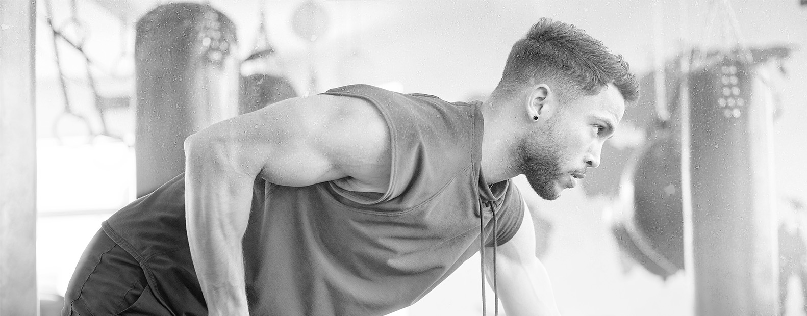 Man training and looking at his phone
