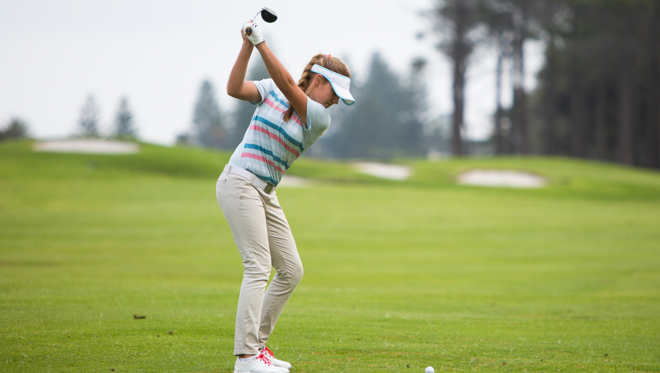 Woman golfing