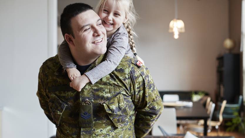 daughters hugging father before deployment