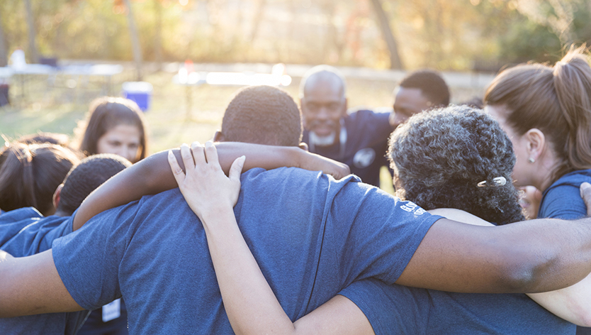 Members of a club huddling in a circle