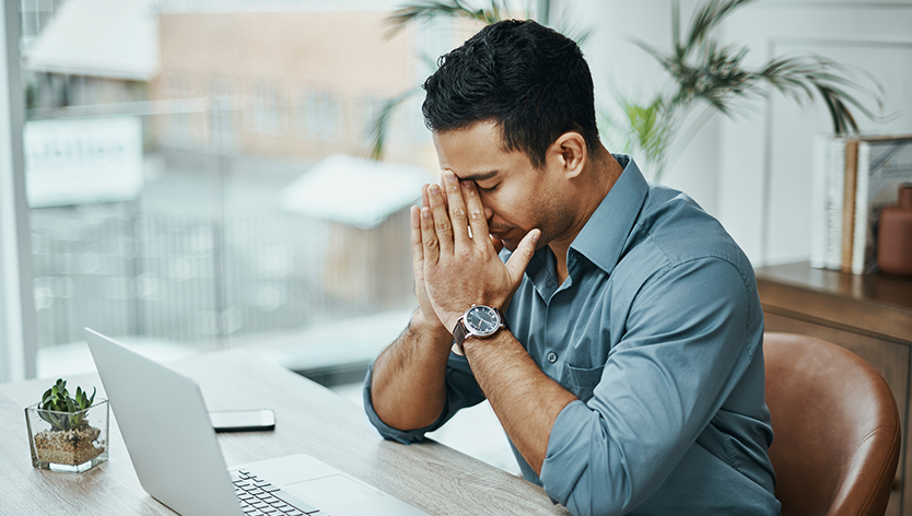 Man feeling overwhelmed while working