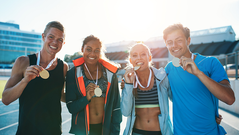 Group of young athletes showing their medals