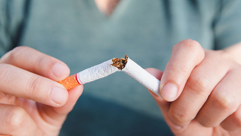 Woman snapping a cigarette in half