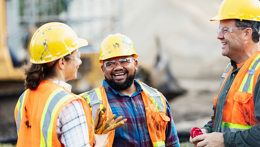 Group of construction workers talking and laughing