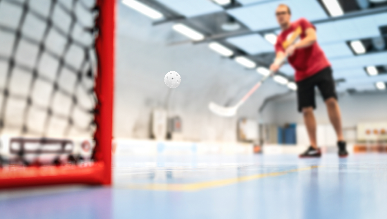 man playing ball hockey