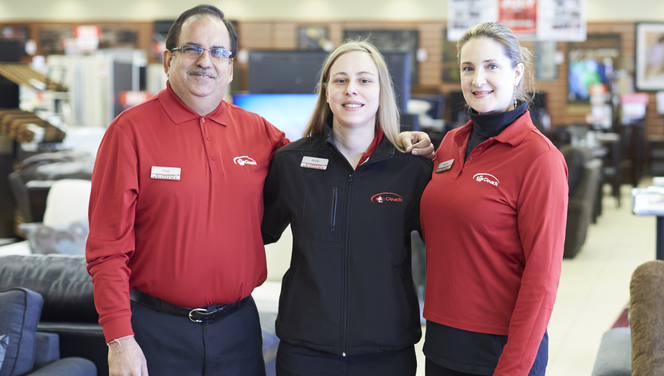 2 women and a man standing in store