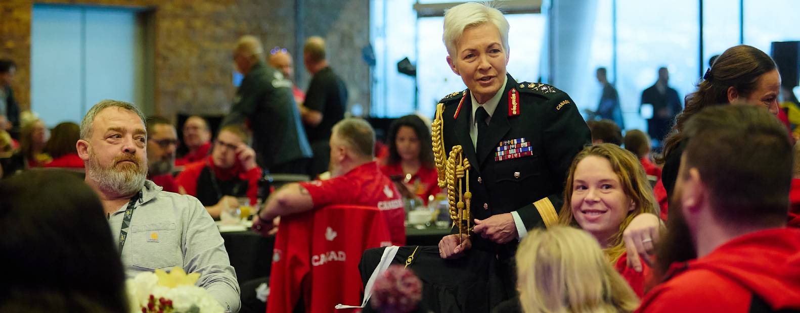 Leadership team member talking to people at a table