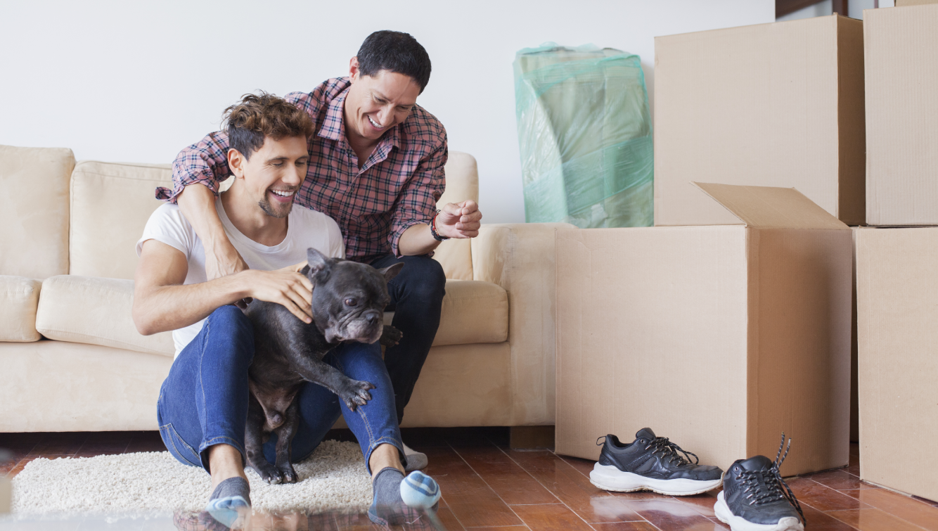 Couple eats around moving boxes