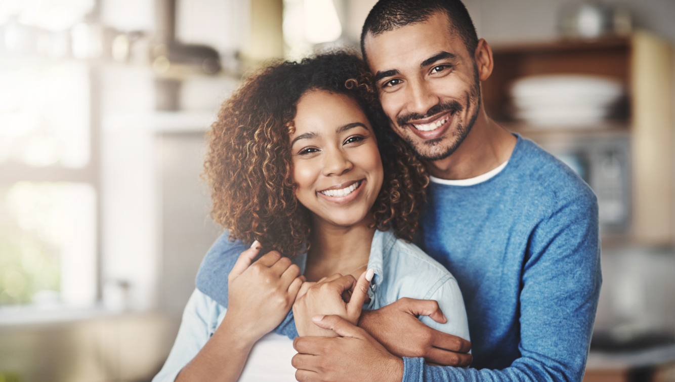 man and woman hugging smiling