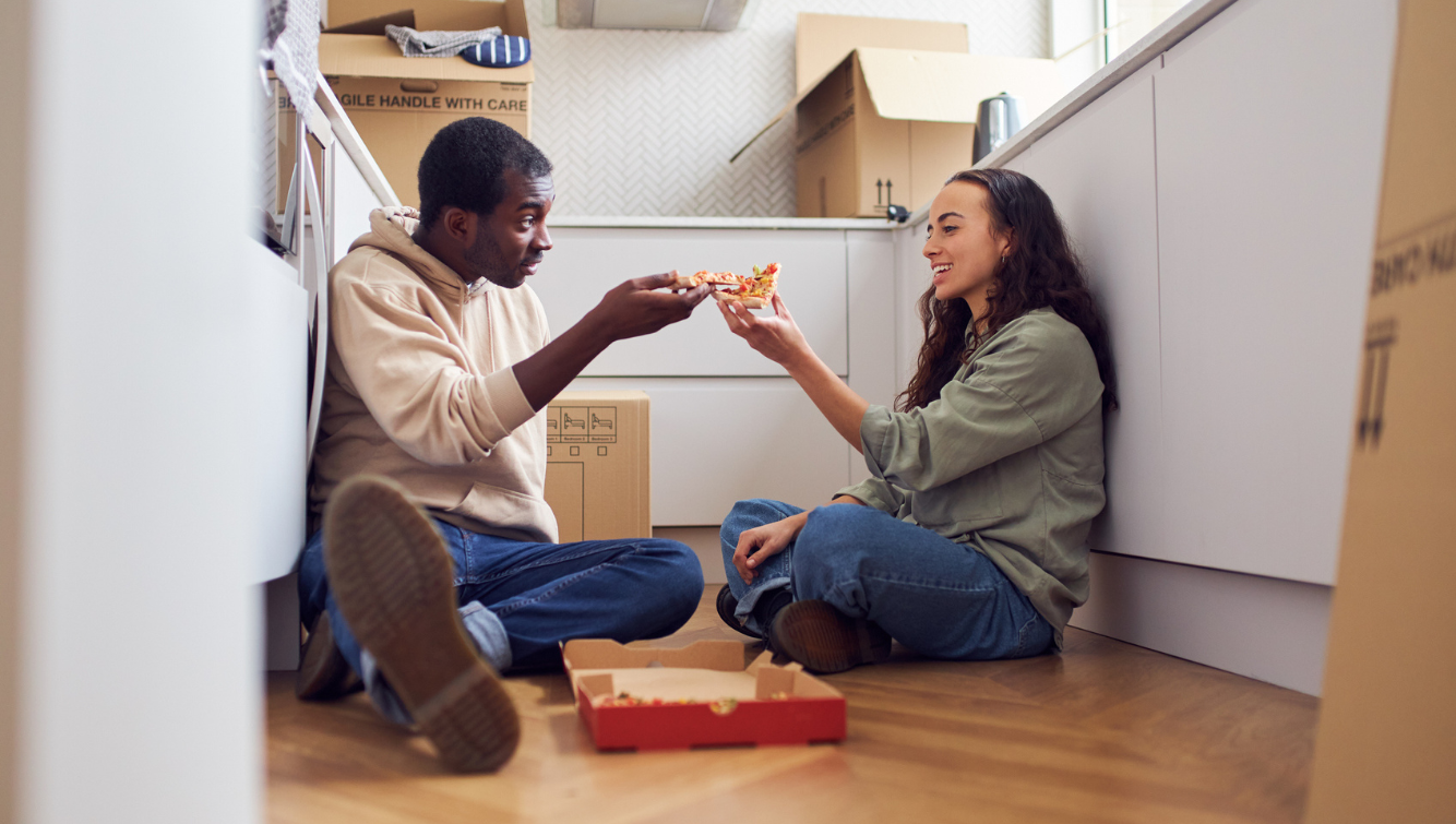 man and woman on floor with pizza