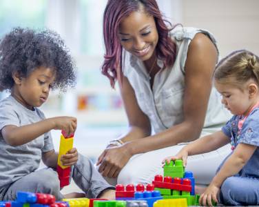 Child care provider playing with kids