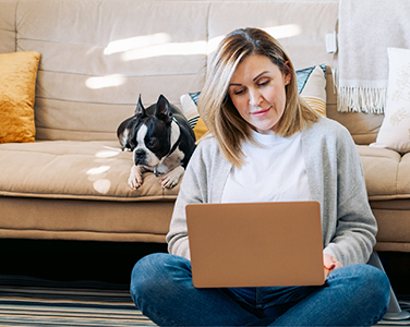 woman with a computer and a dog