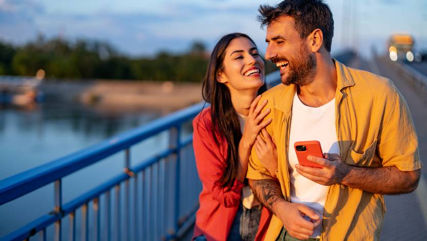 Laughing couple on a bridge