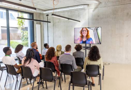 Woman on tv screen with crowd