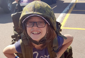 Young girl with military helmet