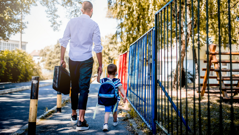 A dad walking his son to school