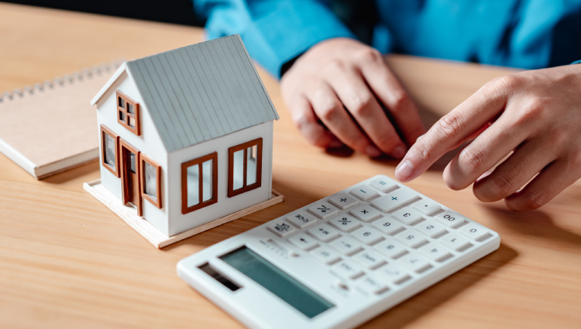 House model next to a calculator