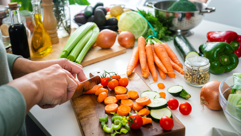 Hands cutting veggies