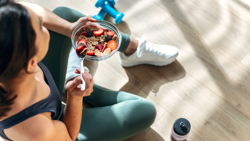 A woman training holding a healthy bowl
