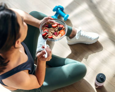 A woman training holding a healthy bowl