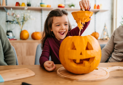 Girl carving a pumpkin
