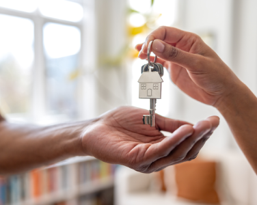 Hands holding home keys