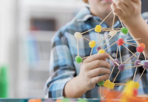 boy creating sculpture with toothpicks