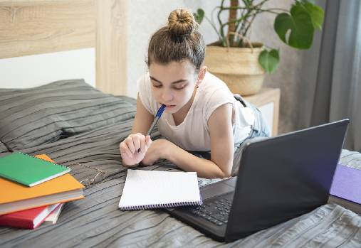 girl studying on bed