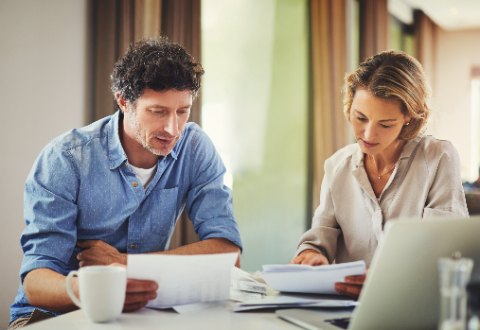 Man and woman looking at financial papers