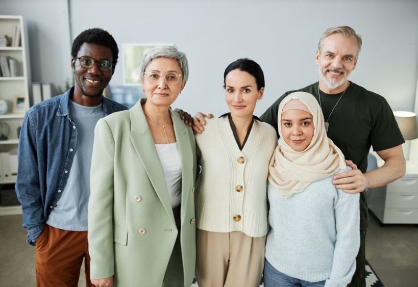 group of multicultural adults standing and smiling