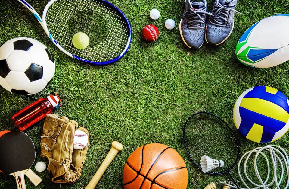 An image of sports equipment laying in a circle on turf.