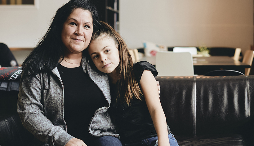 mom and child hugging on couch