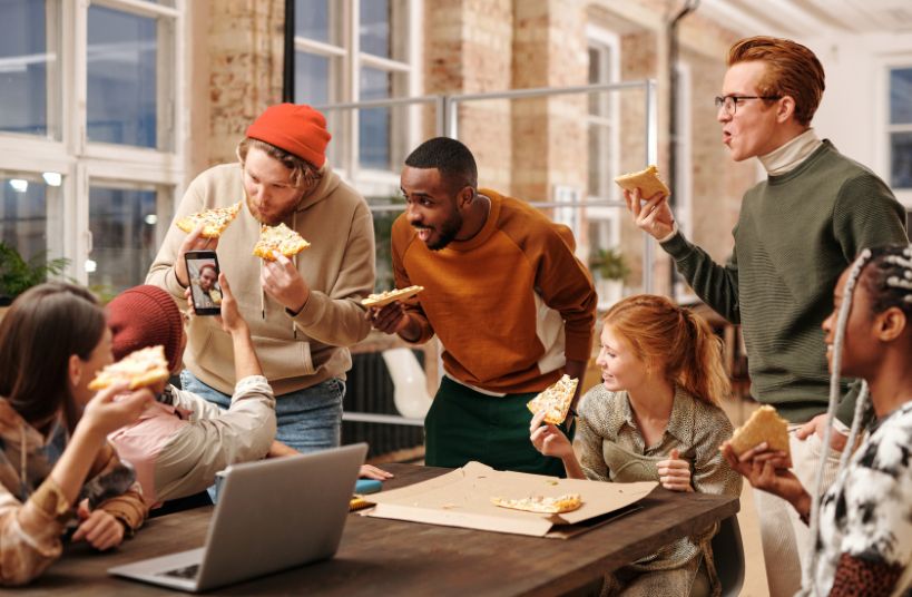 adults eating pizza
