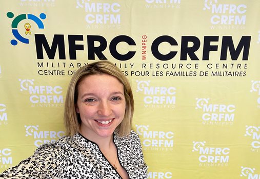 A lady in front of the Winnipeg MFRC media wall
